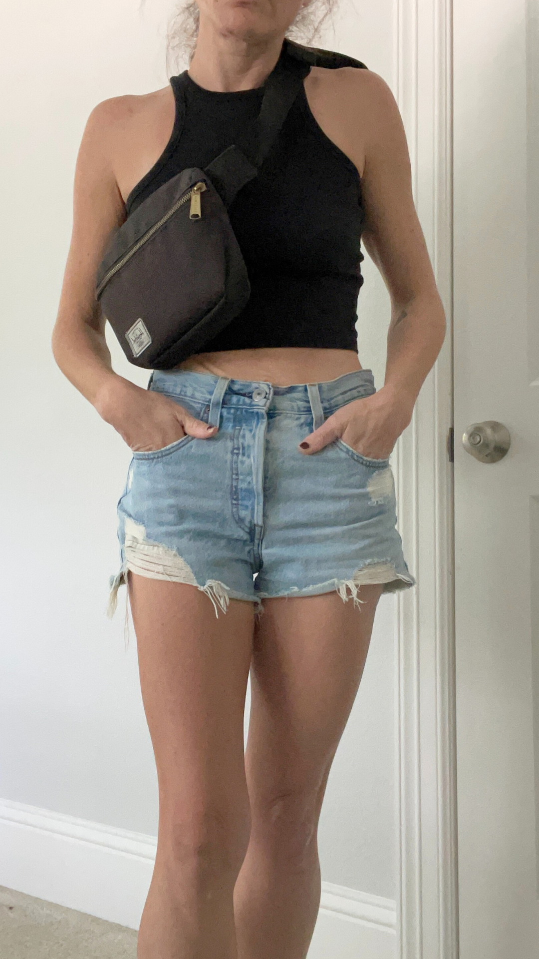 Outfit featuring Levi's 501 Original denim shorts paired with a black tank top and Herschel Fanny Pack