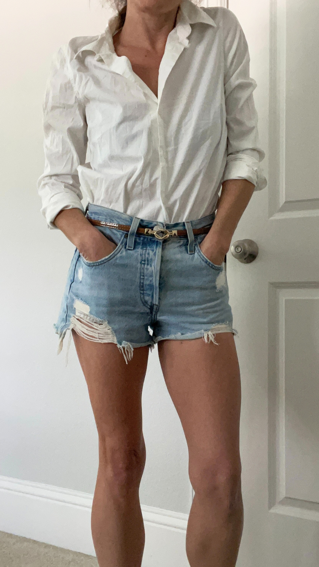 Outfit featuring Levi's 501 Original denim shorts paired with a white button-up shirt.